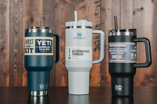 A Yeti Rambler, a Stanley Quencher, and the Outdoor Revival Tumbler sitting next to each other