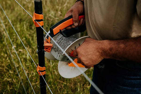 Gallagher turbo wire being installed on a post