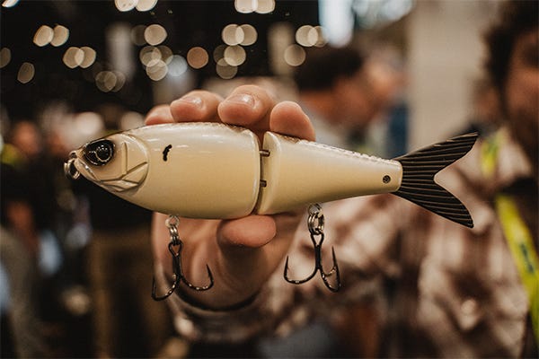 Custom-designed Tater Hog x Strike King multi-jointed swimbait in a lifelike bass colorway, showcased on a display stand at ICAST 2025.