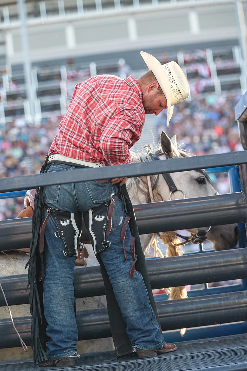 Jesse Kruse preparing to ride saddle bronc behind the chutes at the Great Falls Rodeo