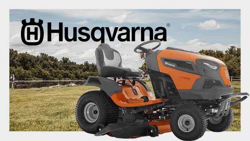 A display of a Husqvarna lawn mower available for sale with a well maintained lawn in the background.