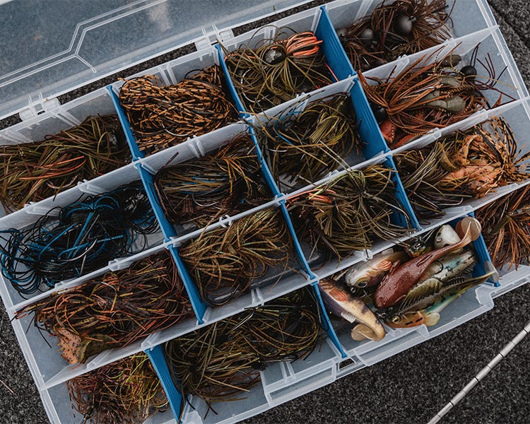 tackle box full of different colored jigs