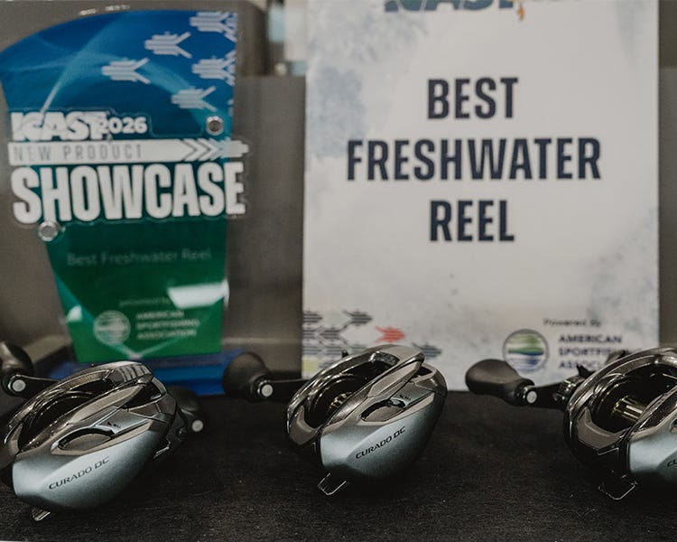 the new curado dc 150a from shimano on display at the icast 2026 booth with best new showcase award in the background