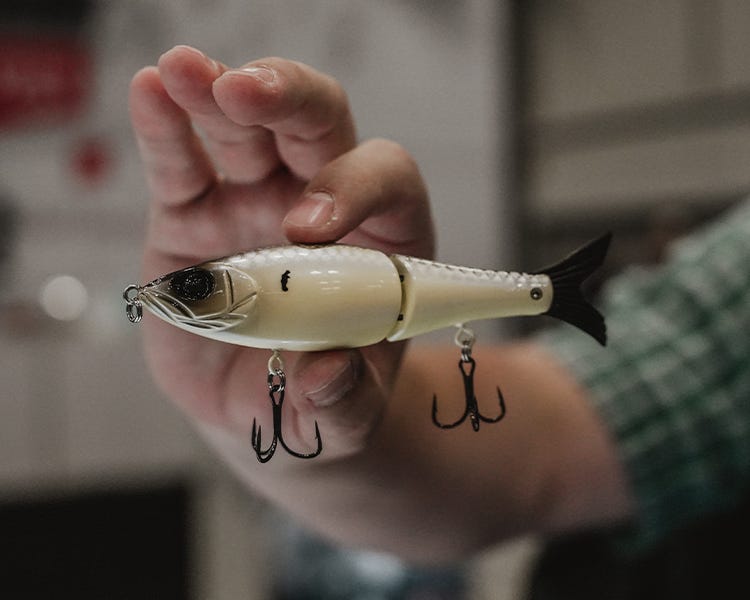the new hustlin hog from strike king and tator hog being held up at the icast 2026 booth