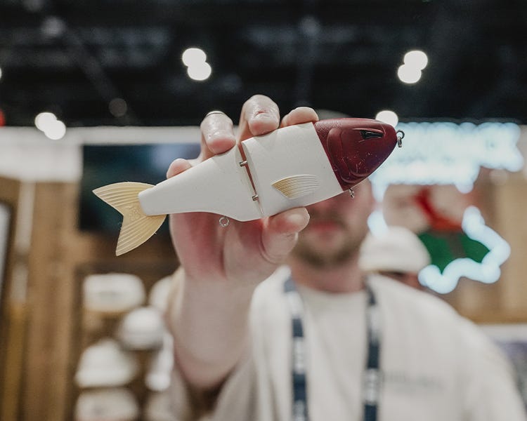 throwback baits booth icast 2026 holding up the metro glide swimbait