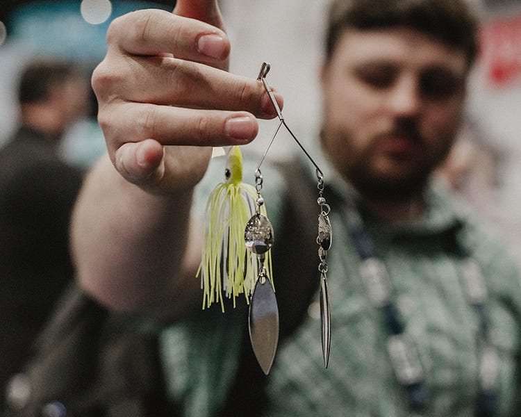 the new two time spinnerbait from strike king being held up at the icast 2026 booth