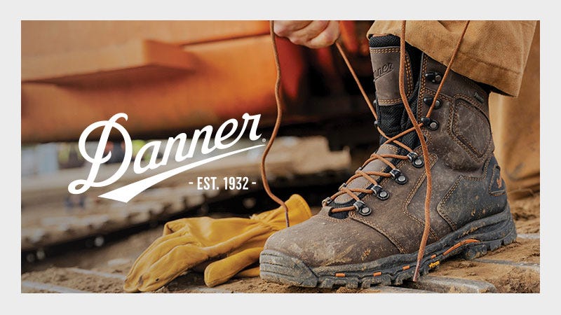 A pair of Danner boots resting on a construction site, highlighting their durability and functionality for construction work.