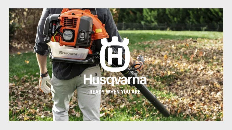 Husqvarna Chainsaw being used on a tree with a orange Husqvarna Logo