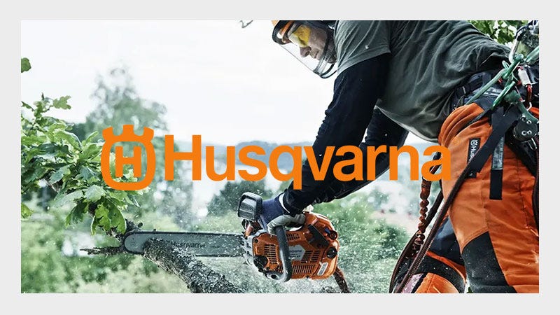 Husqvarna Chainsaw being used on a tree with a orange Husqvarna Logo