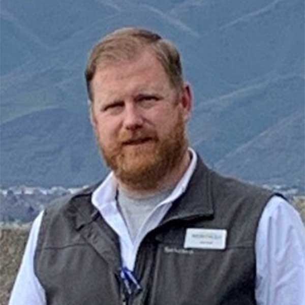 North 40 Lewiston, Idaho store manager Jerrad White posing infront of an Idaho mountain range