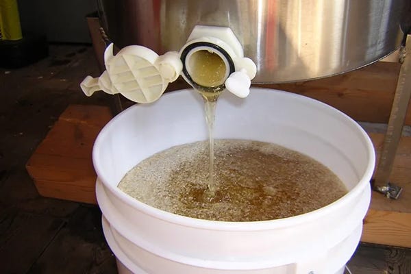 Honey pouring into a bucket. 
