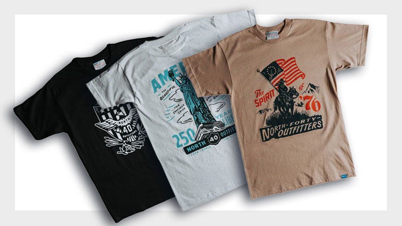 Three graphic t-shirts are displayed; the first is black with a white logo, the second is light gray with teal and black graphics featuring the Statue of Liberty, and the third is tan with an illustration of a man holding an American flag