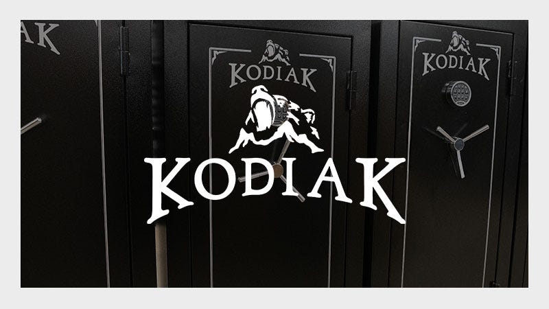 Black safe doors with "Kodiak" branding and a bear graphic. Each door features a combination dial and silver handle. Rugged, secure appearance.