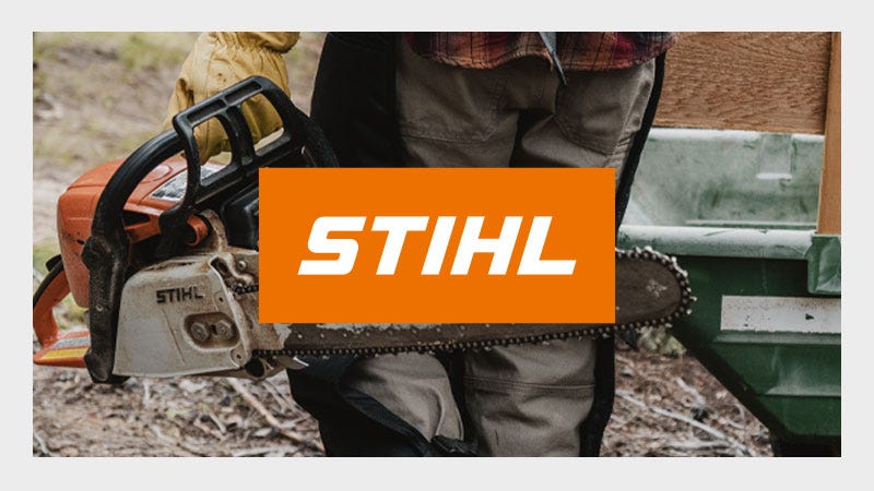 Person holding a Stihl chainsaw, wearing work gloves and pants, standing outdoors. The image has a prominent "STIHL" logo in orange and white.