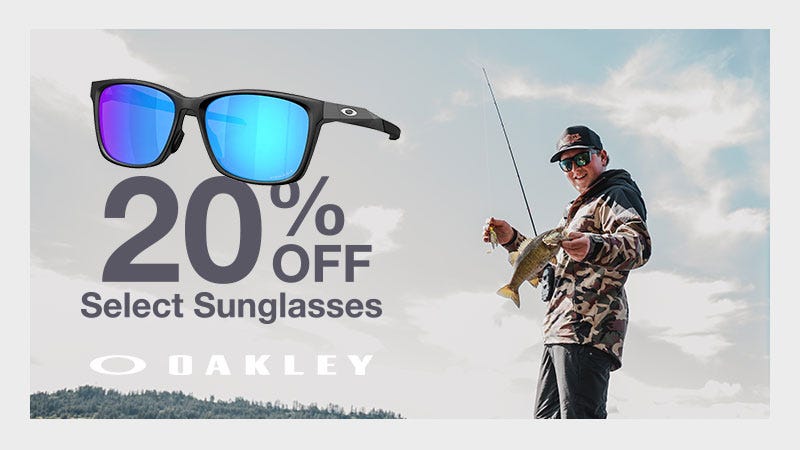 Low upward shot of man holding fish towards camera. Text reads to the left of subject "20% Off Select Sunglasses: Oakley"