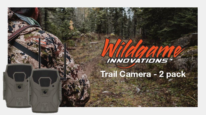 Behind shot of man on a trail in the woods. Product image of game cam on the left. Negative space to the right has overlay text that reads "Wildgame Innovations Trail Camera - 2 pack"