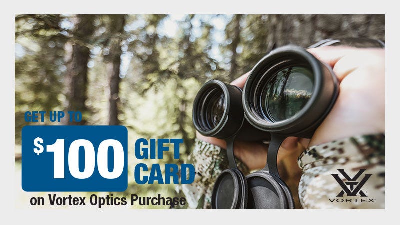 Extreme close up shot of man holding binoculars from a low angle in the woods. Text reads "$100 Gift Card on Vortex Optics Purchase."