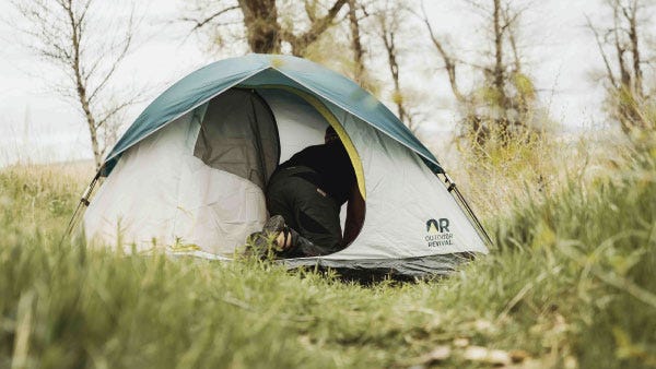 Outdoor Revival tent in a grass covered clearing