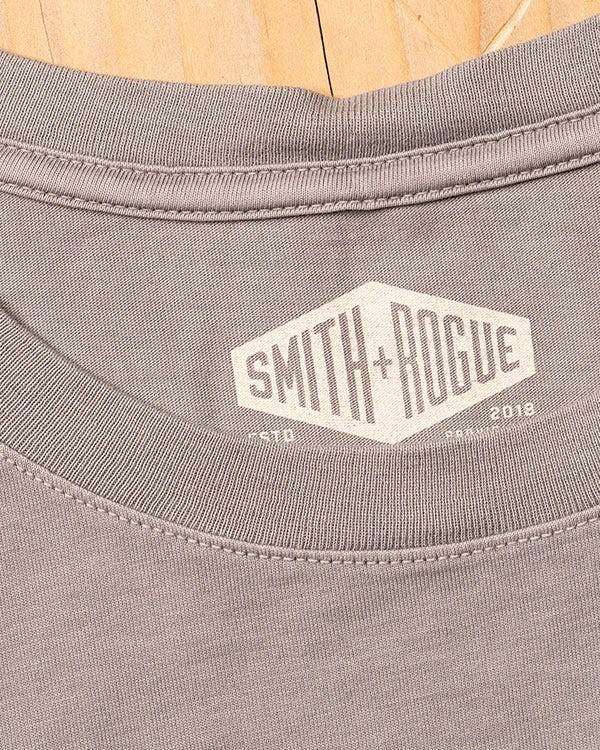 Close-up of gray Smith + Rogue Pima cotton tee featuring ribbed collar stitching and printed interior brand logo detail.