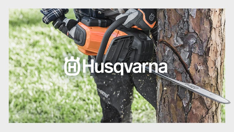 Husqvarna Chainsaw being used on a tree with a white Husqvarna Logo