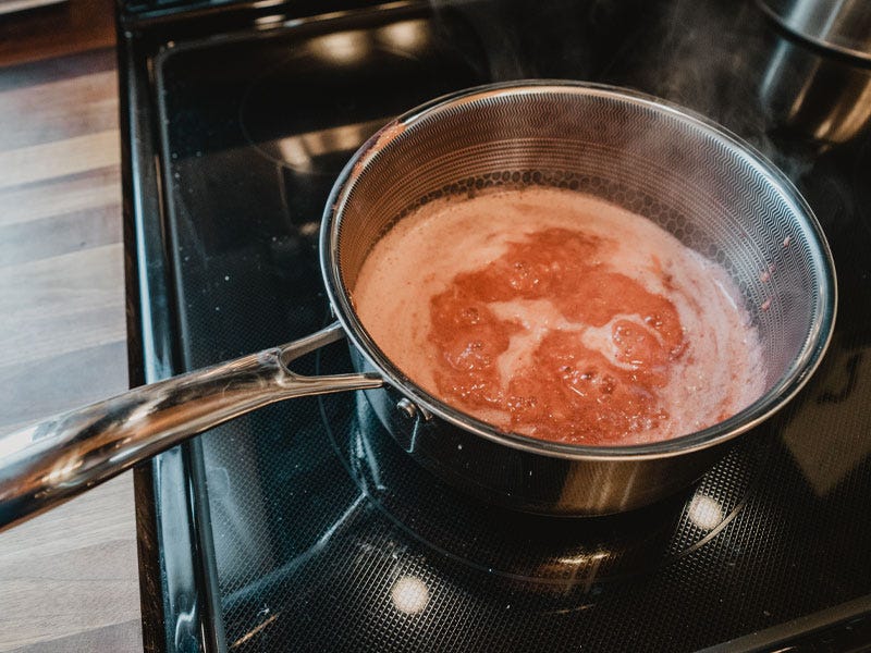 Strawberry mixture reducing on electric stovetop