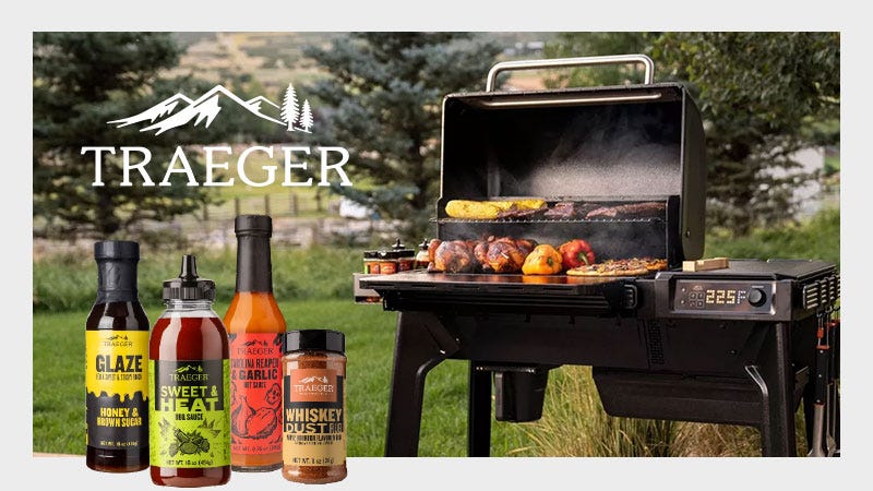 Traeger Grill with Food Grilling on the Racks. Traeger Sauces are in the Foreground of the Shot. Traeger Logo Overlaid.