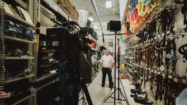 Standing infront of lighting and camera equipment, Former Store Manager Tony Wilson gives an interview at the Spokane, WA North 40 location.