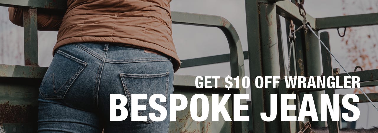Image of a woman from behind on a green fence with close up on her jeans. Text reads "Get $10 OFF Wrangler Bespoke Jeans"