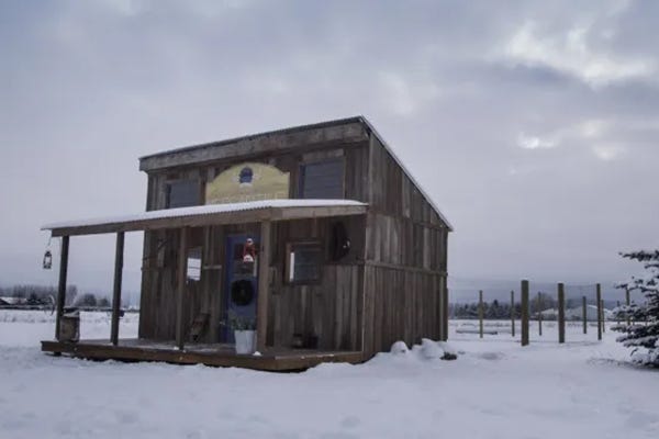 Chicken coop in snow with large run.