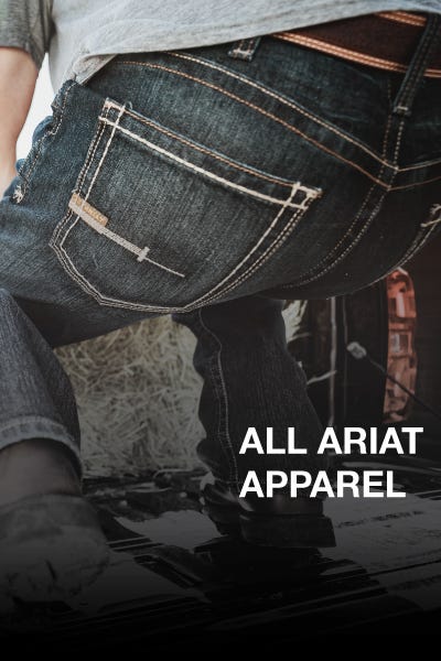  A man kneeling next to a sign that reads 20% off all Ariat apparel.