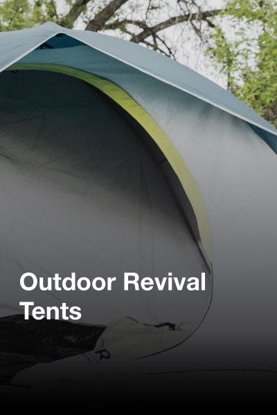 A collection of outdoor revival tents displayed in an open field, featuring bright colors against a backdrop of nature.