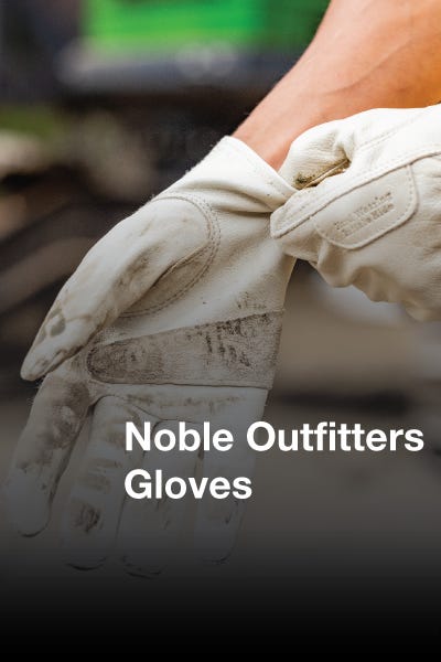 Close-up of noble outfitter's gloves, highlighting the fine material and stitching details, resting on a rustic table.
