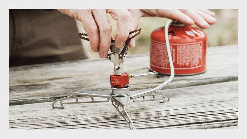 A black cooking pot featuring a sturdy metal handle for easy lifting and pouring.