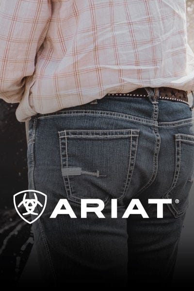  A close-up of the back of men's jeans with the "Ariat" logo visible.