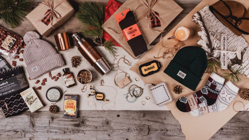 a collection of stocking stuffer gift items on wood table